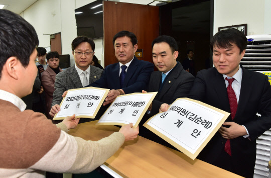 더불어민주당 강병원 의원(왼쪽부터), 민주평화당 김정현 대변인, 바른미래당 채이배 의원, 정의당 김종철 대변인이 12일 오전 여야 4당 공동으로 5·18 민주화운동을 비하한 자유한국당 김진태, 이종명, 김순례 의원에 대한 징계안을 국회 의안과에 제출하고 있다.   연합뉴스
